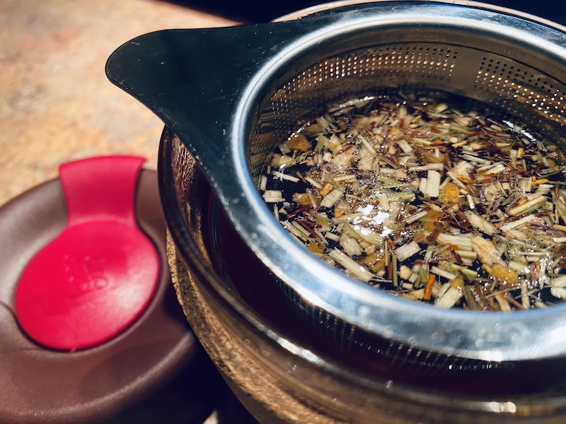 Cup of herbal tea in a KeepCup reusable travel cup.